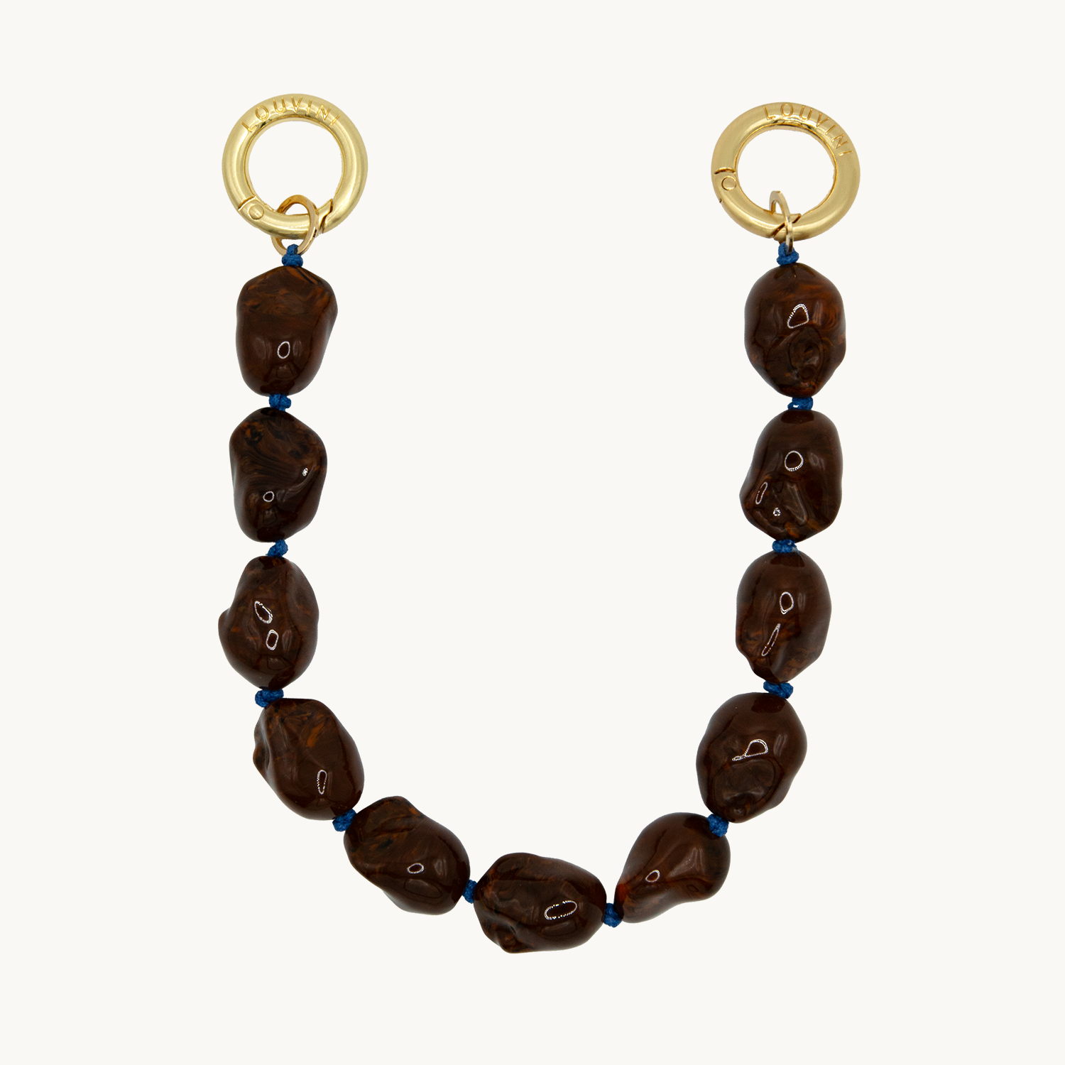 Bracelet pour téléphone avec pierres en résine et anneaux dorés