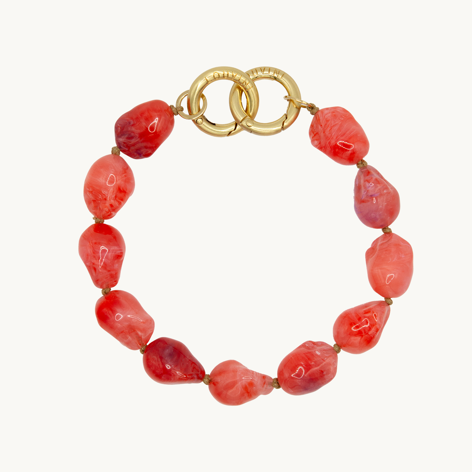 Bracelet pour téléphone avec pierres en résine et anneaux dorés