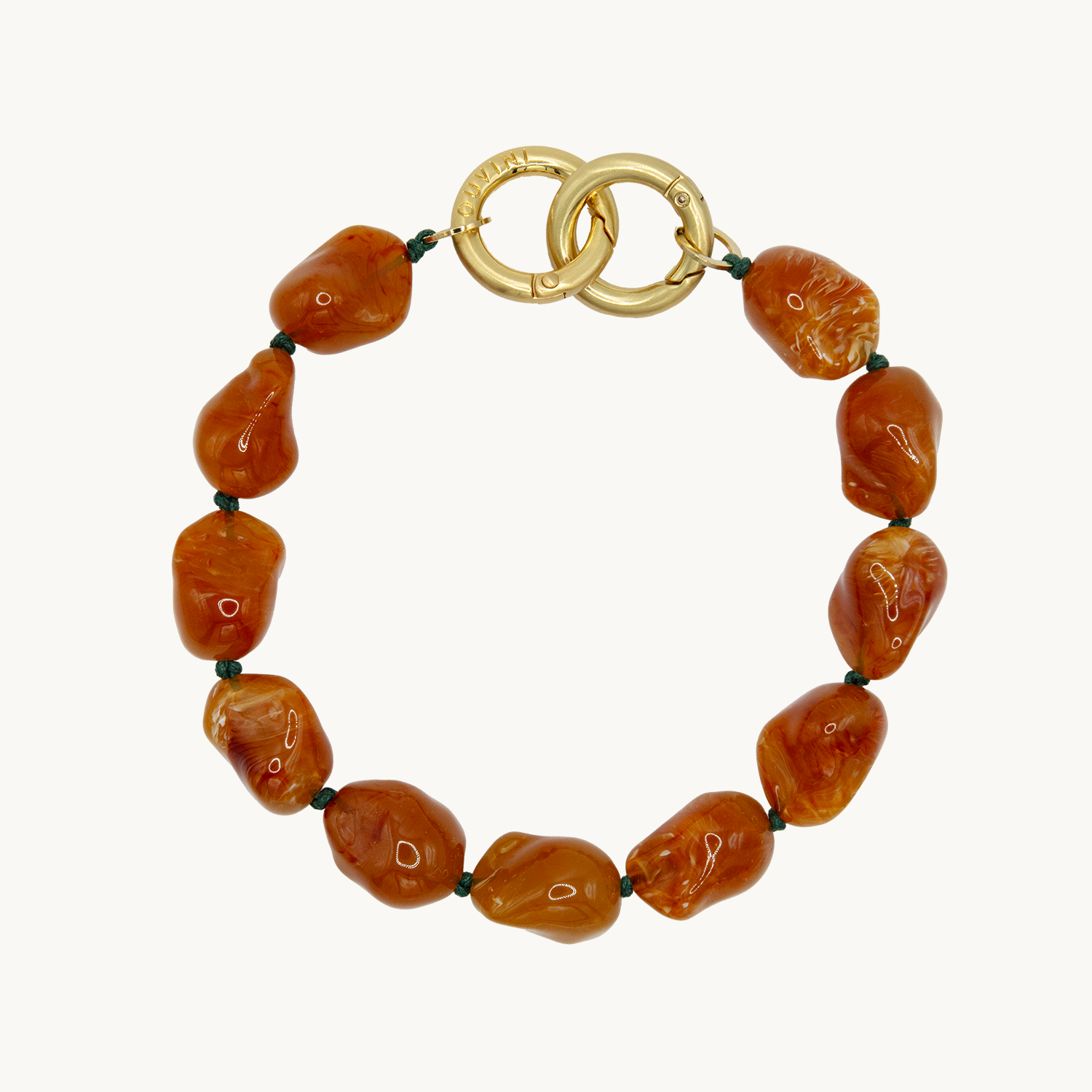 Bracelet pour téléphone avec pierres en résine et anneaux dorés