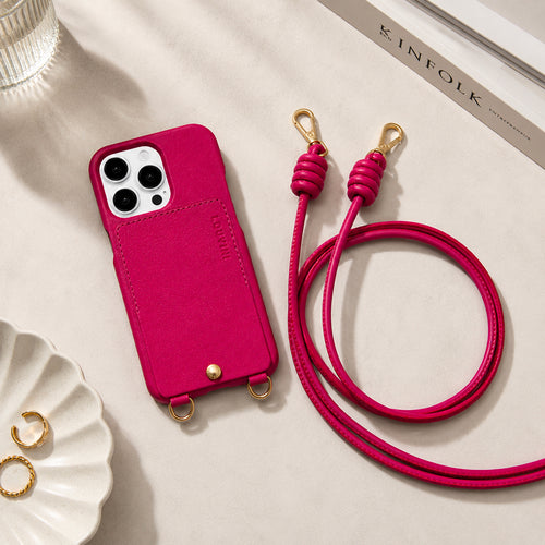coque iphone en cuir fuchsia avec porte carte et anneaux intégrés et cordon de téléphone en cuir fuchsia